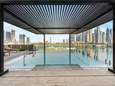 a swimming pool with a view of the city at Chic 1 Bedroom with Palm Views in Palace Beach Residence in Dubai