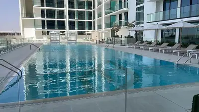 a large swimming pool in the middle of a building at Premium Stylish Studio in JVC in Dubai