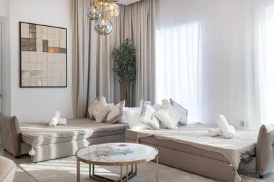 a living room with two beds and a table at Luxury Apartments - Urban Oasis by Missoni - Business Bay - Canal View - 10 Minutes from Dubai Mall Burj Khalifa in Dubai