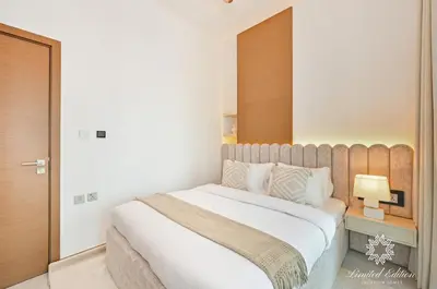 a bedroom with a large bed with a wooden headboard at Luxury Apartments - Urban Oasis by Missoni - Business Bay - Canal View - 10 Minutes from Dubai Mall Burj Khalifa in Dubai