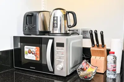a microwave sitting on top of a counter at Canal View Studio near Dubai Mall in Dubai