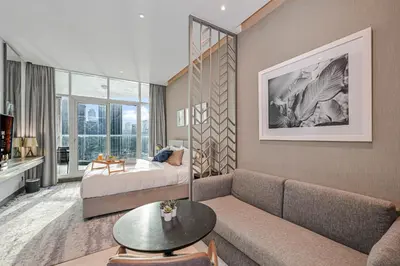 a living room with a couch and a bed at Canal View Studio near Dubai Mall in Dubai