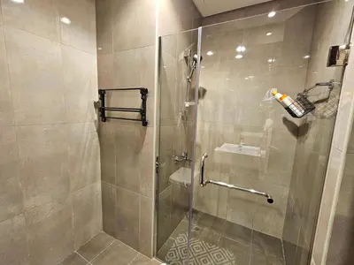 a bathroom with a shower with a glass door at Merano Studio 920 in Dubai