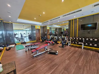 a gym with a bunch of treadmills and machines at Merano Studio 920 in Dubai