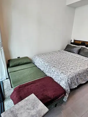 a bedroom with a bed and two pillows at Merano Studio 920 in Dubai