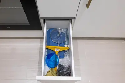 a drawer in a kitchen with some items in it at BLVD Retreat - Luxury Oasis with Private Jacuzzi and Iconic Burj Khalifa Views in Dubai