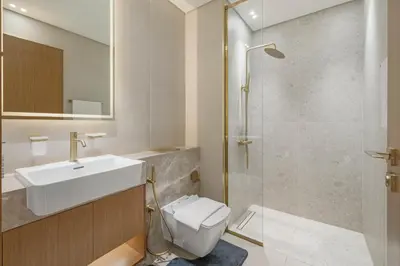 a bathroom with a sink and a toilet and a shower at BLVD Retreat - Luxury Oasis with Private Jacuzzi and Iconic Burj Khalifa Views in Dubai