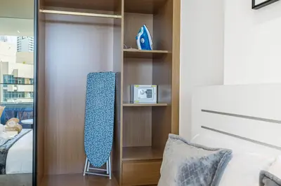 a bedroom with a closet with a bed and a mirror at BLVD Retreat - Luxury Oasis with Private Jacuzzi and Iconic Burj Khalifa Views in Dubai