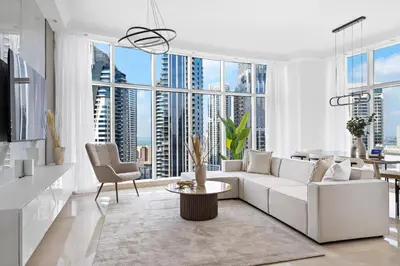 a living room with white furniture and large windows at Luxury 4BR w Marina Views Near Beach & Mall in Dubai