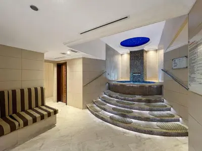 a lobby with a staircase in a building at Luxury 4BR w Marina Views Near Beach & Mall in Dubai