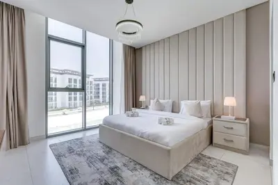 a bedroom with a large bed and a large window at PVH - Lagoon View 1BR - District One in Dubai
