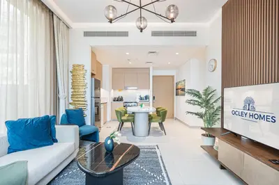 a living room with a couch and a table at Creek Home with Private Terrace & Direct Pool Access in Dubai