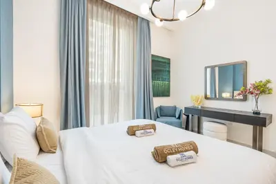 a hotel room with a bed and a desk at Creek Home with Private Terrace & Direct Pool Access in Dubai