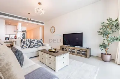 a living room with a couch and a tv at 3BR Overlooking Sea, Ain Dubai, and Bluewaters Island, Walking Distance to the Beach, The Address Residences, Jumeirah Beach Residence by Deluxe Holiday Homes in Dubai