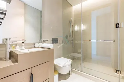 a bathroom with a shower and a toilet and a sink at 3BR Overlooking Sea, Ain Dubai, and Bluewaters Island, Walking Distance to the Beach, The Address Residences, Jumeirah Beach Residence by Deluxe Holiday Homes in Dubai