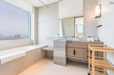 a bathroom with a tub and a sink at 3BR Overlooking Sea, Ain Dubai, and Bluewaters Island, Walking Distance to the Beach, The Address Residences, Jumeirah Beach Residence by Deluxe Holiday Homes in Dubai