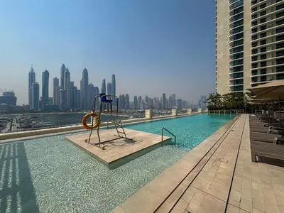 a pool with a playground in the middle of a city at Frank Porter - Marina Vista in Dubai