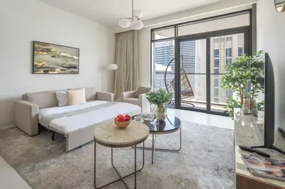 a living room with a couch and a table at Frank Porter - Marina Vista in Dubai