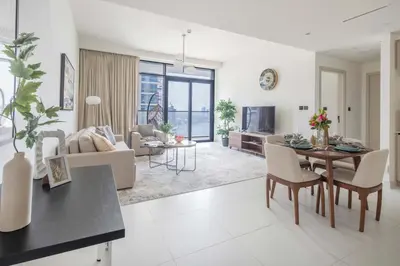 a living room with a table and a dining room at Frank Porter - Marina Vista in Dubai