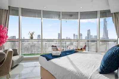 a large bed in a room with a large window at Panoramic Burj Khalifa View - Damac Distinction Downtown Dubai in Dubai