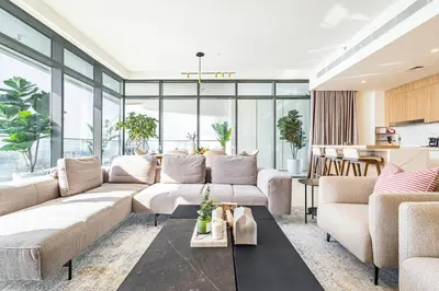 a living room with a couch and a table at Luxury Stay, 3BR Palm View, Beach Vista in Dubai
