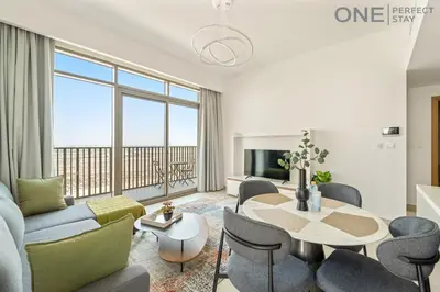 a living room with a couch and a table at Modern 1-Bedroom Apartment in Al Furjan With Pool & Gym in Dubai