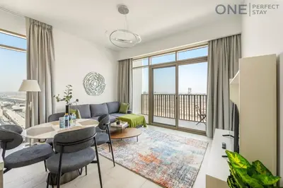 a living room with a couch and a table at Modern 1-Bedroom Apartment in Al Furjan With Pool & Gym in Dubai