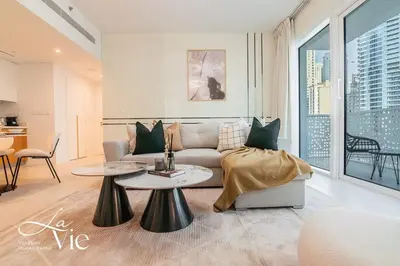 a living room with a couch and a table at La Vie, JBR - Exclusive Beach & Pool Access in Dubai