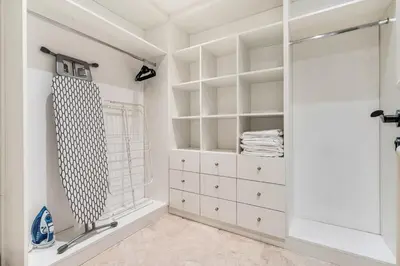 a bathroom with white cabinets and a walk in closet at DAYF-FMT Fairmont Palm with Pool and Beach Access in Dubai