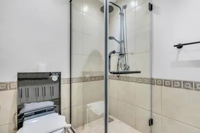 a bathroom with a glass shower with a toilet at DAYF-FMT Fairmont Palm with Pool and Beach Access in Dubai