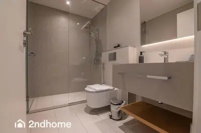 a bathroom with a glass shower and a toilet at Newly Furnished, Beach Access located in La Vie, JBR in Dubai
