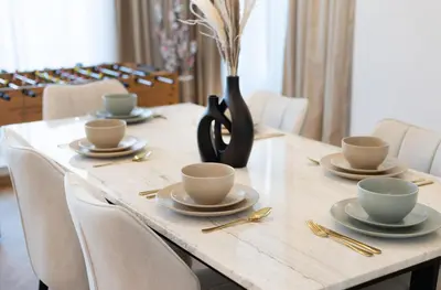 a table with cups and saucers and a vase at Luxury 3BR Gem in the Heart of Dubai Marina in Dubai