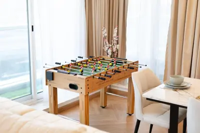 a table with a chess board on it in a living room at Luxury 3BR Gem in the Heart of Dubai Marina in Dubai