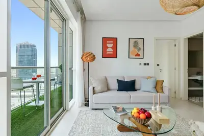 a living room with a couch and a glass table at DAYF-WST Stunning Marina Views at Marina Promenade in Dubai