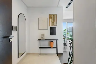 a hallway with a table with an orange vase on it at DAYF-WST Stunning Marina Views at Marina Promenade in Dubai