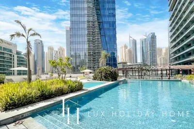a swimming pool in a city with tall buildings at LUX The Silverene Marina View Studio 2 in Dubai