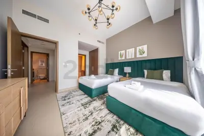 a hotel room with two beds and a bathroom at Tourist Spot, Sea View - Next to Bluewaters & JBR in Dubai