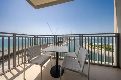 a balcony with chairs and a table on the beach at Tourist Spot, Sea View - Next to Bluewaters & JBR in Dubai