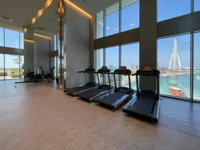 a gym with a bunch of treadmills in a building at Tourist Spot, Sea View - Next to Bluewaters & JBR in Dubai