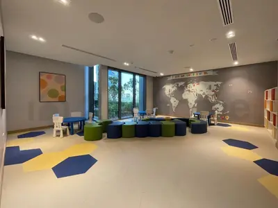 a large room with a waiting area with blue and yellow carpet at Tourist Spot, Sea View - Next to Bluewaters & JBR in Dubai