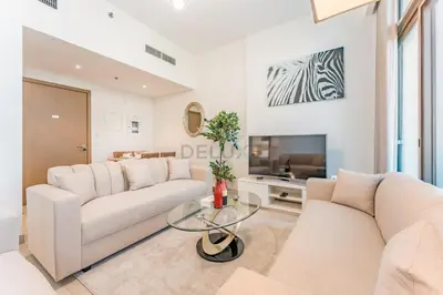 a living room with two white couches and a tv at 1BR with Dubai Creek Views, Near Dubai Frame And Zabeel Park, Fawad Azizi Residence, Al Jadaf by Deluxe Holiday Homes in Dubai
