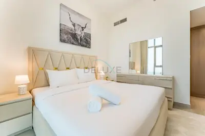 a bedroom with a large white bed and a window at 1BR with Dubai Creek Views, Near Dubai Frame And Zabeel Park, Fawad Azizi Residence, Al Jadaf by Deluxe Holiday Homes in Dubai