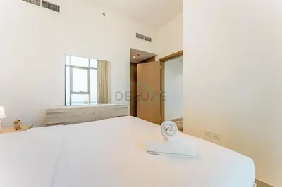 a bedroom with a large bed and a window at 1BR with Dubai Creek Views, Near Dubai Frame And Zabeel Park, Fawad Azizi Residence, Al Jadaf by Deluxe Holiday Homes in Dubai