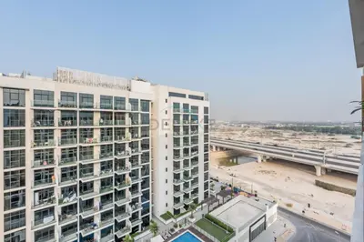 an aerial view of a tall white building at Furnished Studio Near Meydan Racecourse, Minutes to Downtown Dubai, Azizi Riviera 47, Al Merkadh by Deluxe Holiday Homes in Dubai