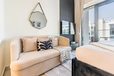 a living room with a couch and a bed at Furnished Studio Near Meydan Racecourse, Minutes to Downtown Dubai, Azizi Riviera 47, Al Merkadh by Deluxe Holiday Homes in Dubai