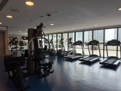 a gym with treadmills and ellipticals in a building at Luxury Stay Dual View Furnished Swimming Pool Gym in Dubai