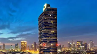 a tall building with a cat sitting on top of it at 2min to Dubai Mall - Pool, Gym, Sauna - Full Burj View in Dubai