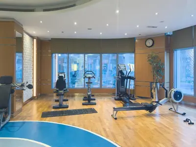 a gym with treadmills and cardio equipment in a building at 2min to Dubai Mall - Pool, Gym, Sauna - Full Burj View in Dubai
