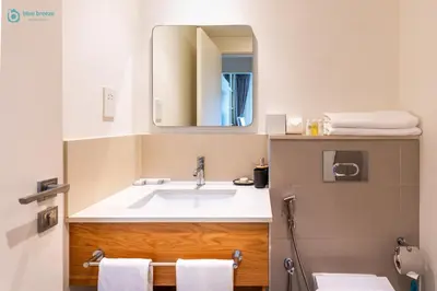 a bathroom with a sink and a mirror at Blue Breeze - Modern 1BR, Dubai Hills, in Dubai