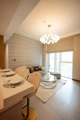 a living room with a couch and a table at Stylish and Charming 1BR in Urban Oasis by Missoni in Dubai